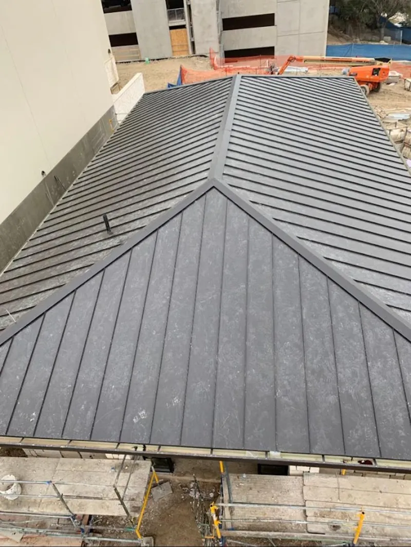 Commercial metal roof construction with crane equipment in Roselle Park